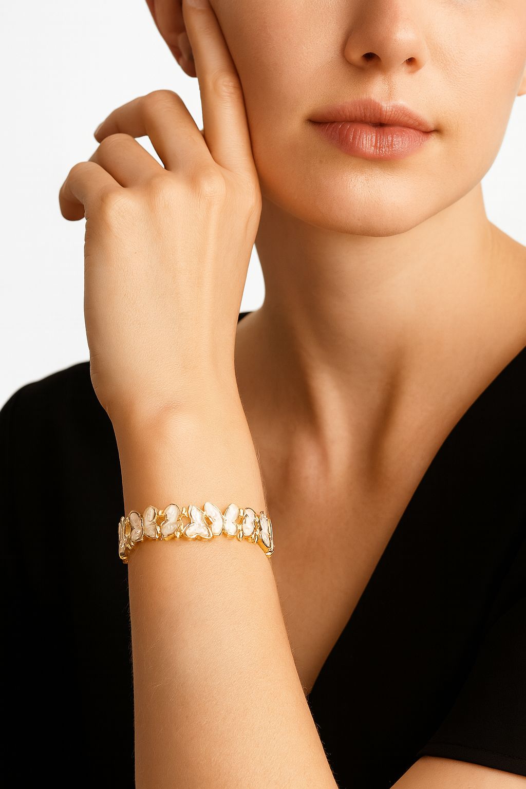 Model wearing gold butterfly bracelet for elegant everyday style.