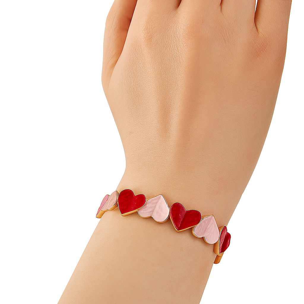 Woman wearing red and pink enamel heart bracelet set in KC gold