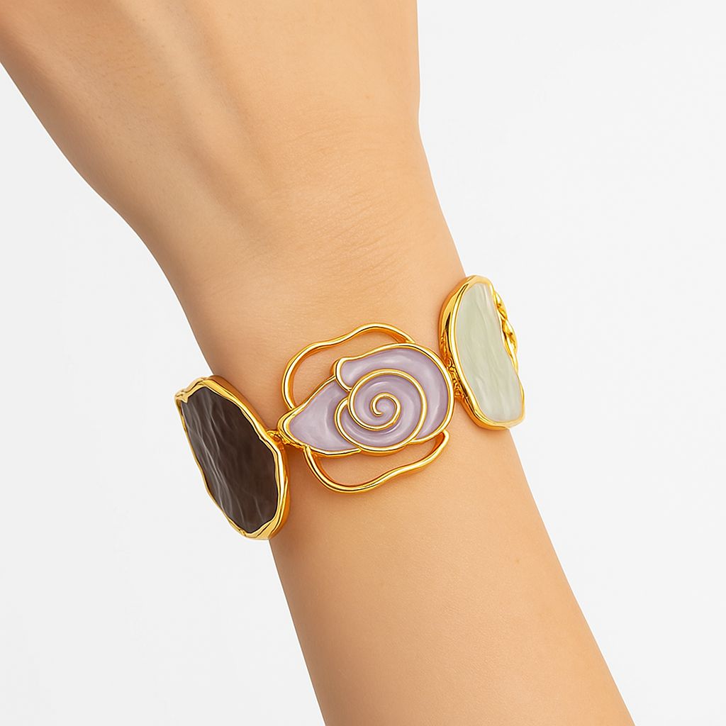 Close-up of colorful abstract enamel bracelet with gold-plated finish