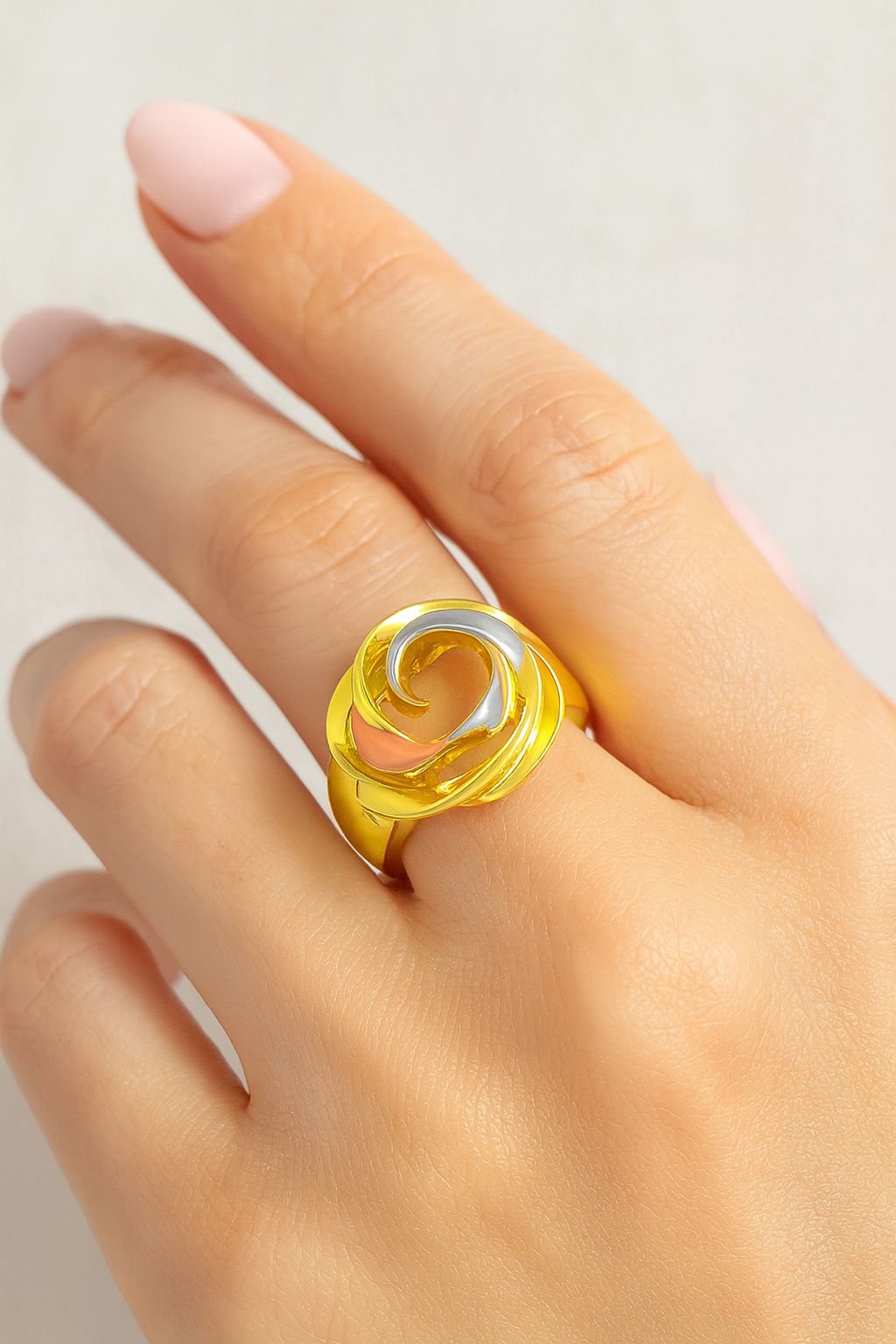 KC gold statement ring with sculptural swirl design