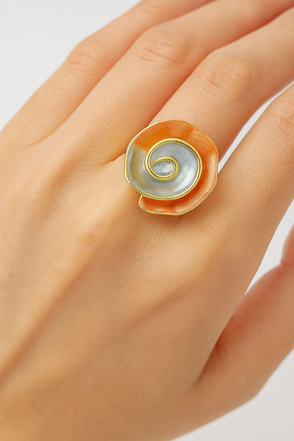 Hand-painted enamel swirl ring with silver and coral tones”