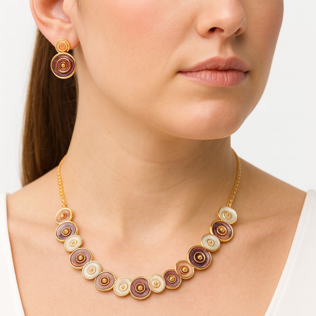 Close-up of hand-painted enamel earrings and gold necklace set