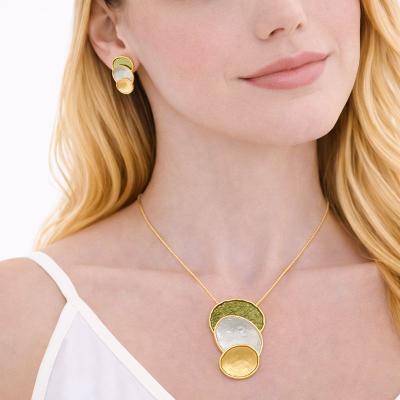 Close-up of hand-painted enamel pendant with KC gold finish