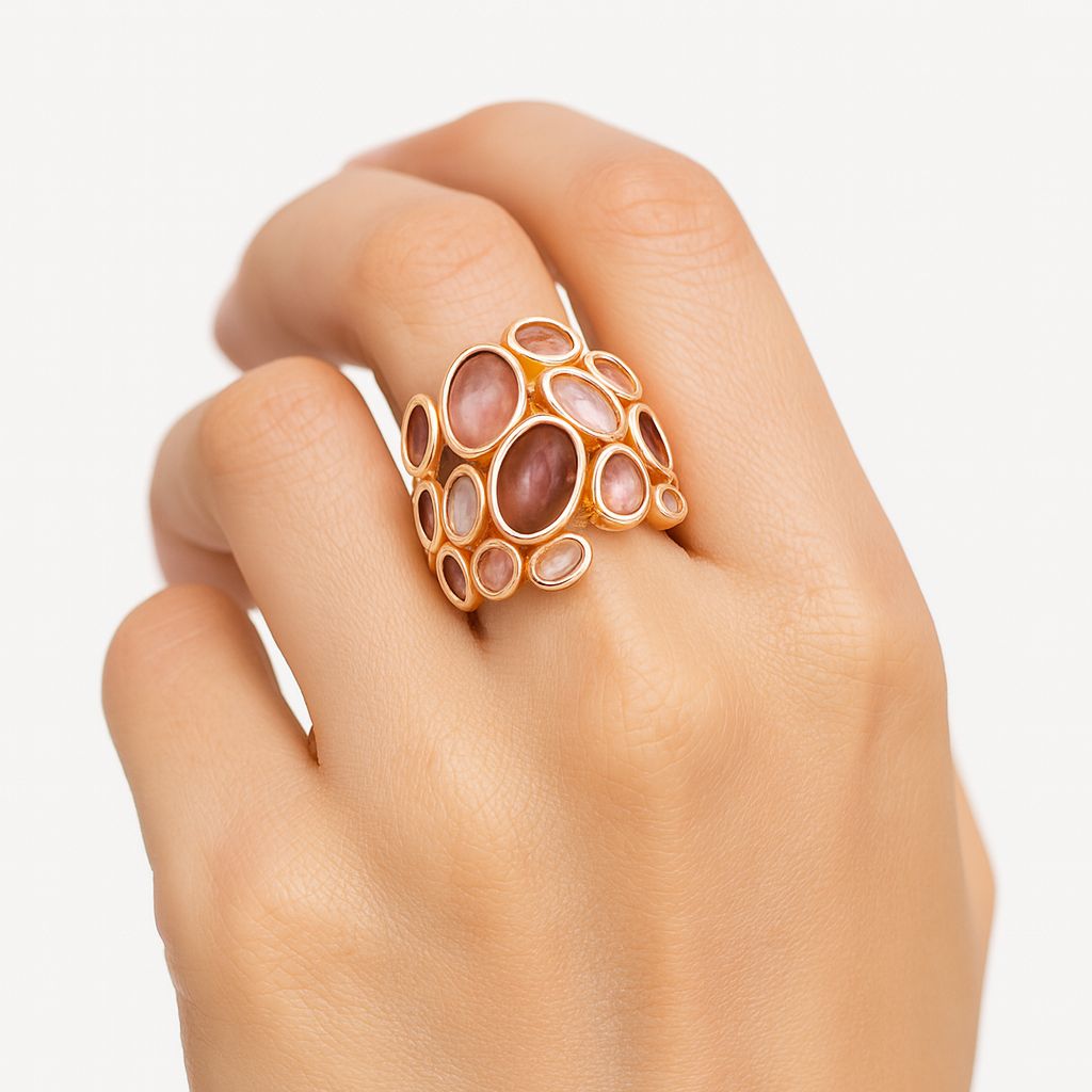 Close-up of hand-painted enamel detailing on gold statement ring