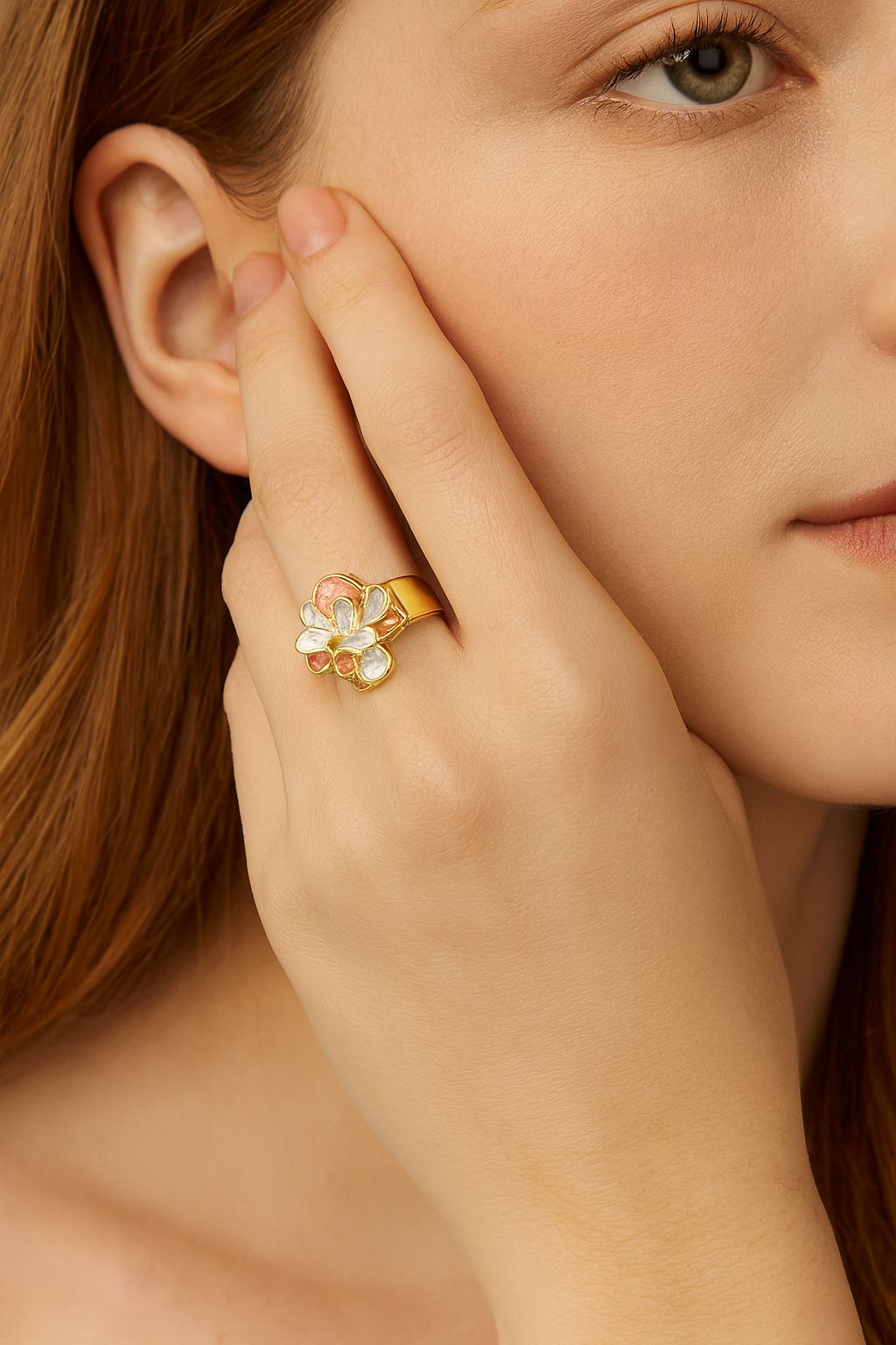 Adjustable gold petal flower ring displayed on female hand