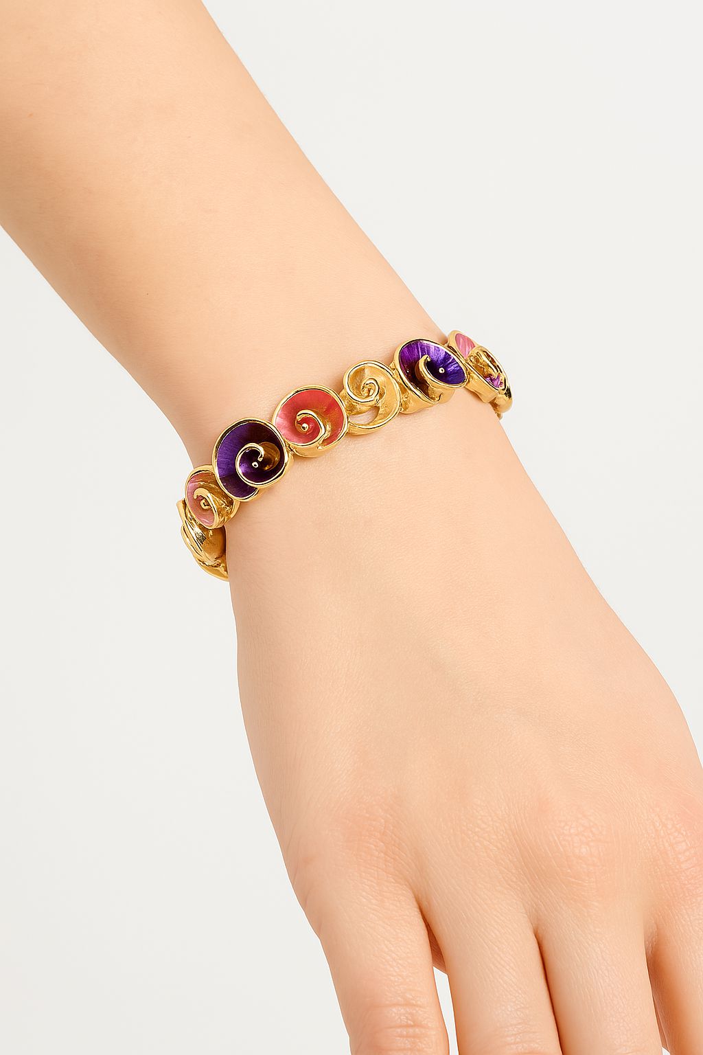 KC gold alloy bracelet with vibrant enamel swirl pattern