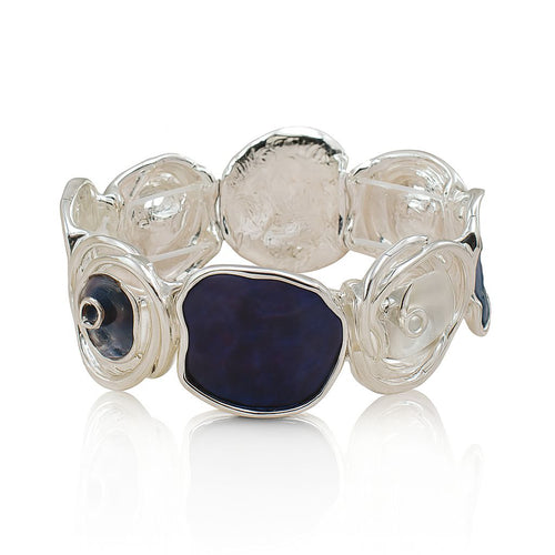 Model wearing artistic blue enamel cuff bracelet