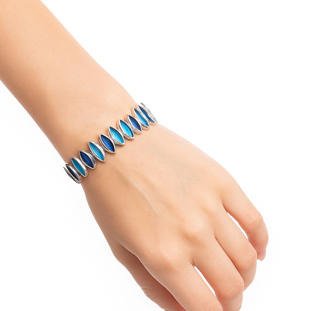Model wearing gradient blue enamel bangle bracelet on wrist