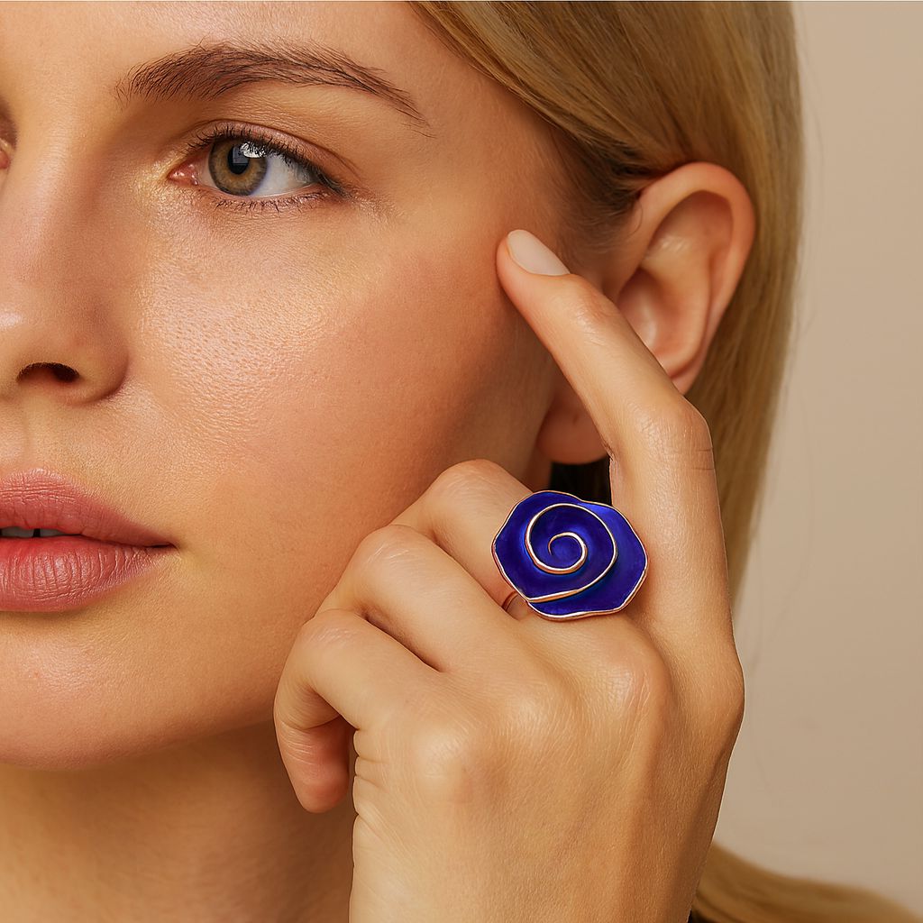 Hand painted blue enamel flower ring worn on finger