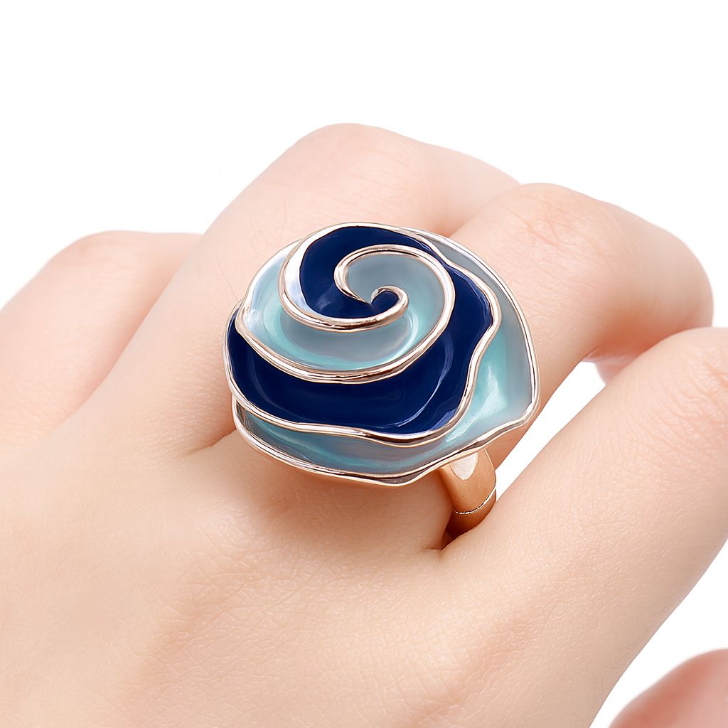 Two tone blue enamel swirl ring worn on finger