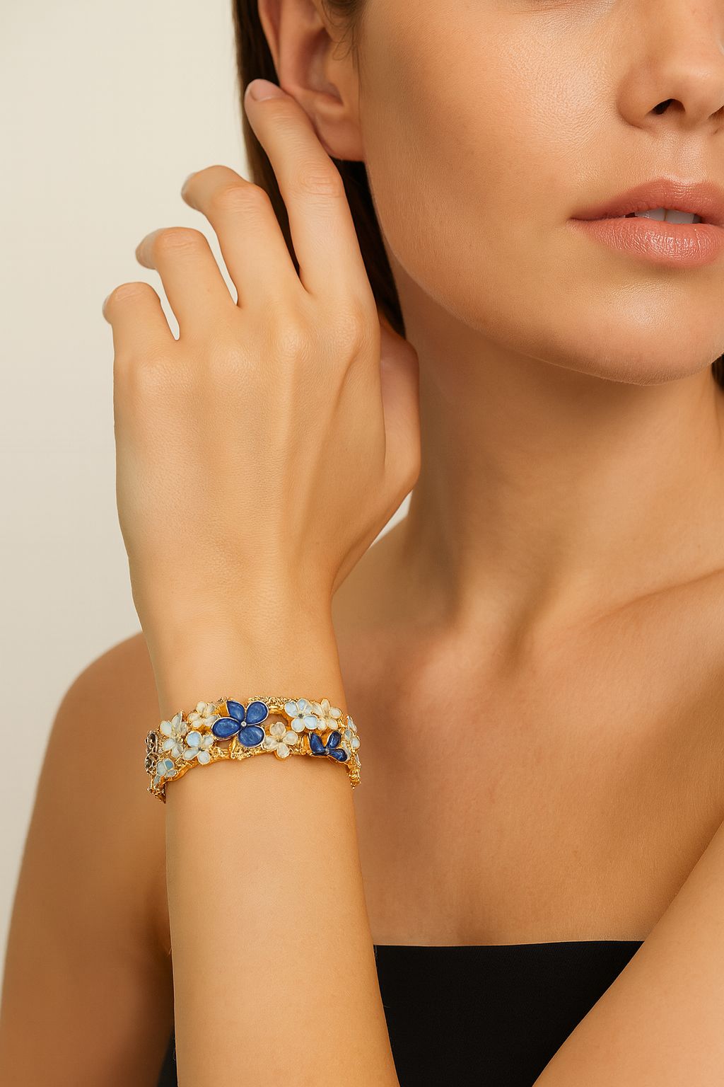 Model wearing blue enamel floral bracelet, elegant style