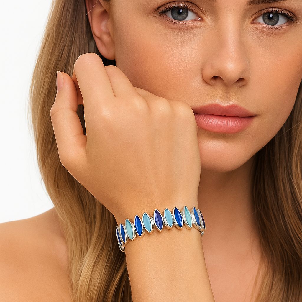 Woman wearing artistic gradient blue enamel bracelet in a minimalist style