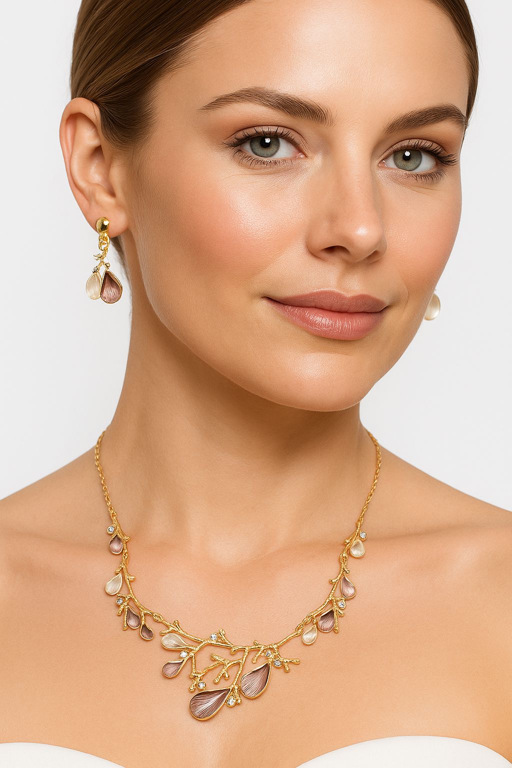 Model wearing botanical branch inspired KC gold plated necklace and earrings