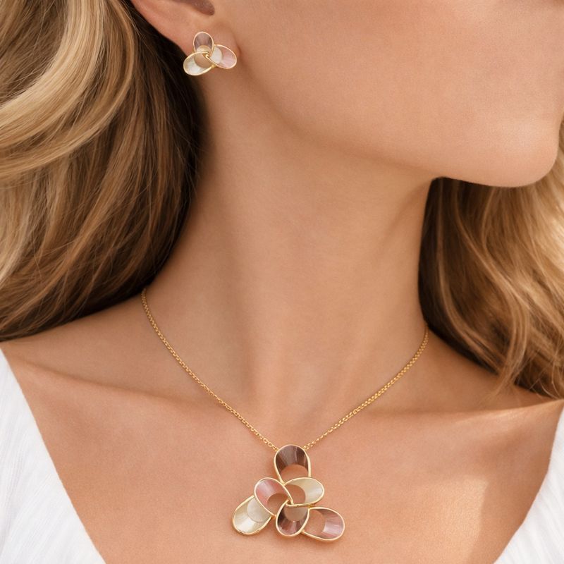 Close-up of hand-painted champagne enamel floral necklace in KC gold