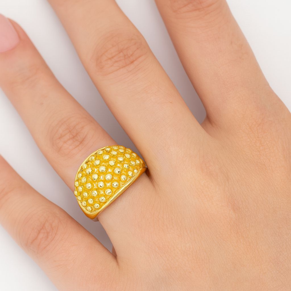 Chunky statement dome ring featuring high-shine gold finish and artistic bead pattern