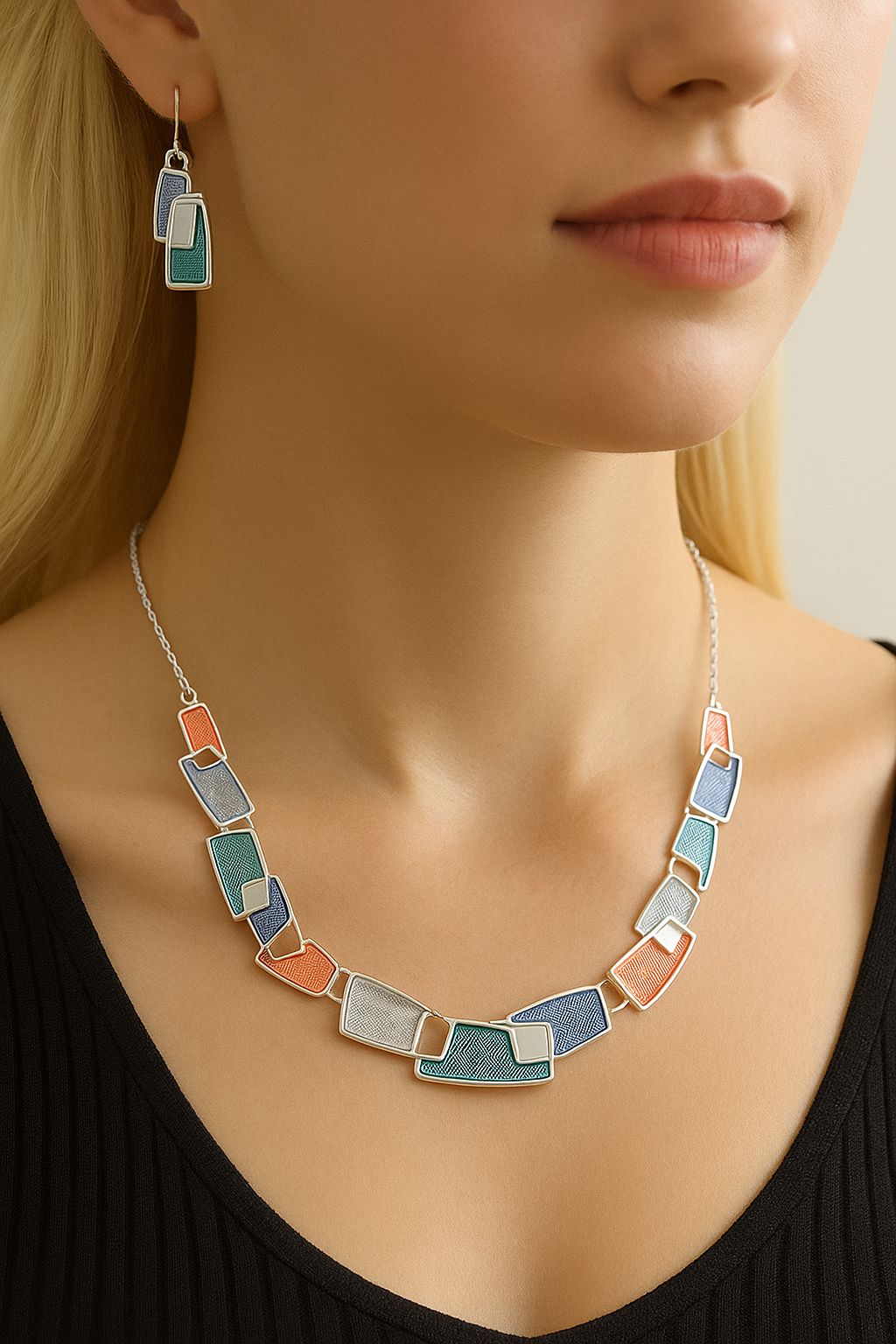 Model wearing modern geometric enamel necklace and matching earrings