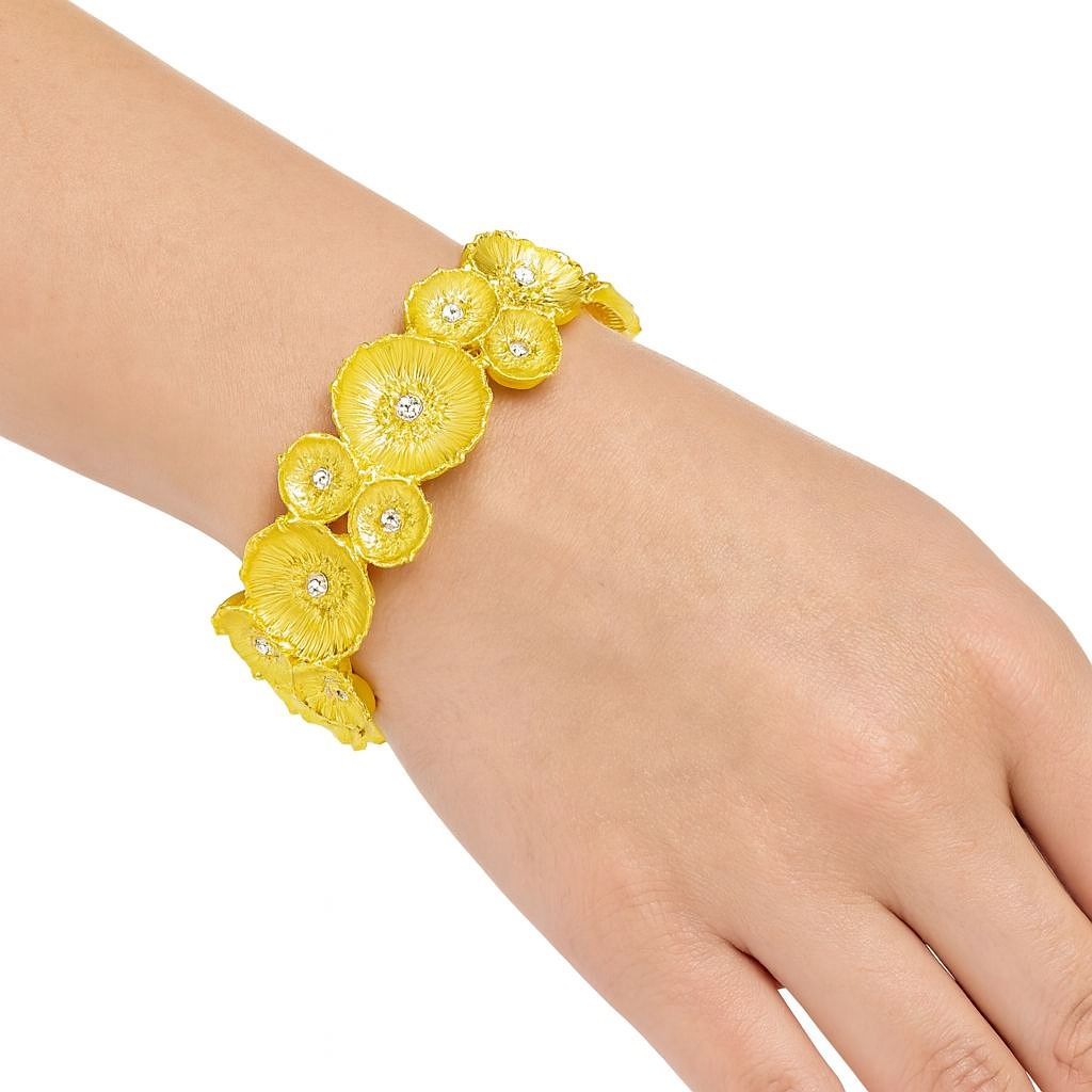 Hand-painted gold flower bracelet with crystal accents on wrist, KC gold plated floral stretch bangle