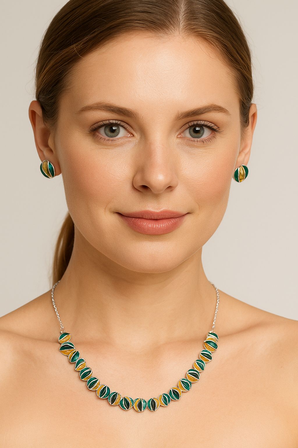Sculpted disc necklace and earrings worn by model