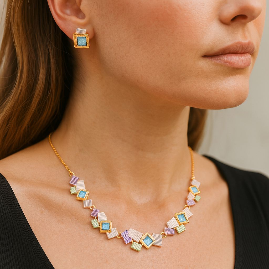 Close-up of hand-painted enamel gold earrings with KC gold finish