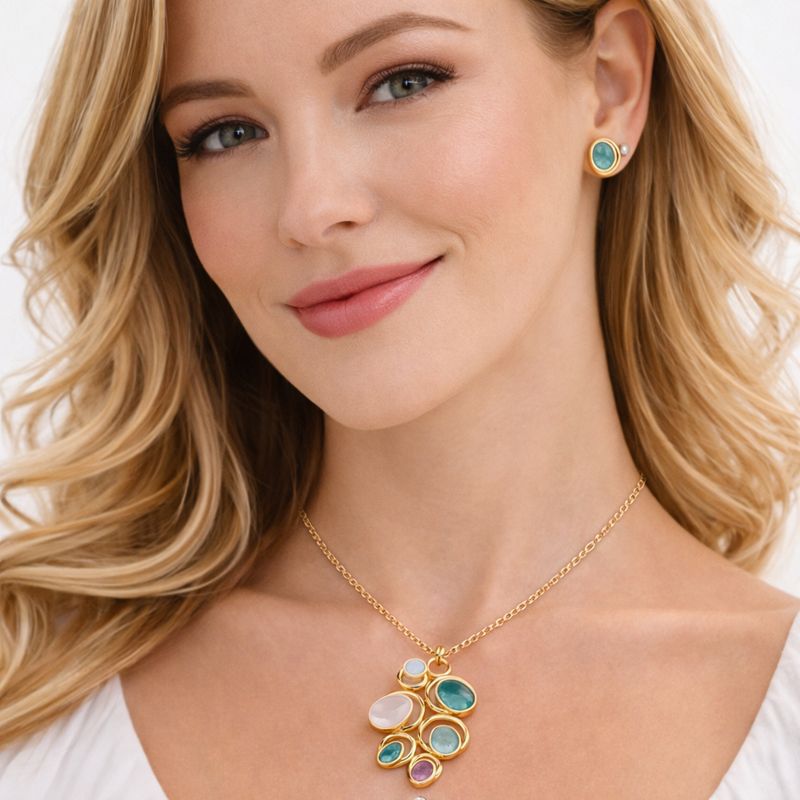 Woman wearing hand painted enamel gold necklace and earrings jewelry set