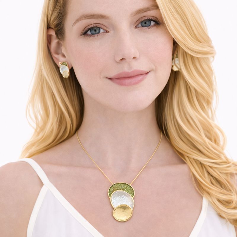 Model wearing enamel pendant necklace with matching earrings