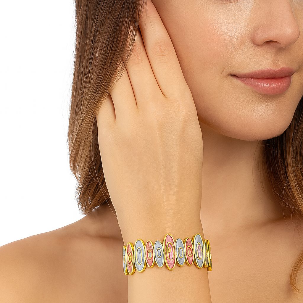 Model wearing handcrafted enamel KC gold bracelet with oval design