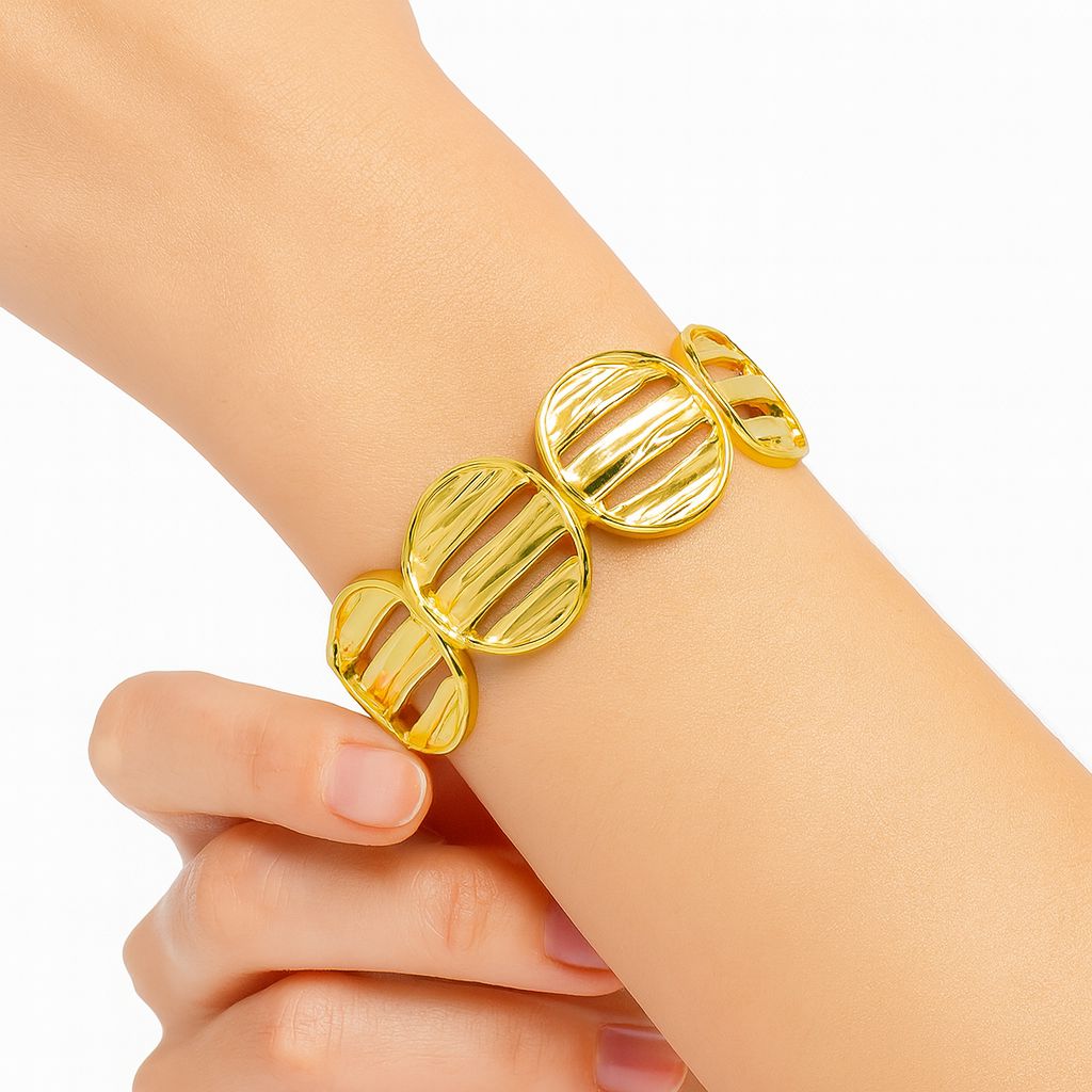 Gold-plated modern hollow circle bracelet with hand-textured design on wrist