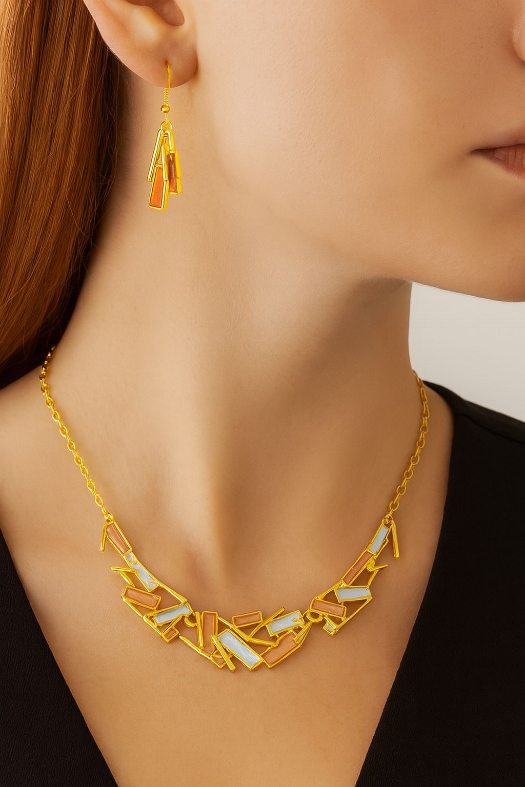 “Hand-painted enamel geometric earrings in KC gold on model”