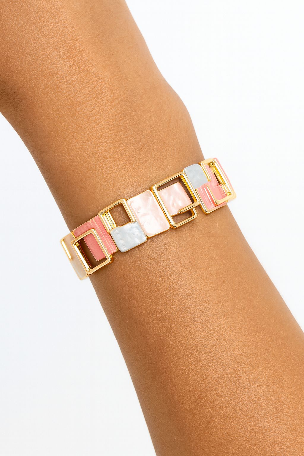 Model wearing geometric pastel enamel bracelet on wrist