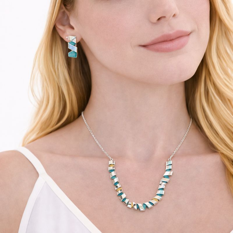 Woman wearing modern geometric enamel necklace and earrings