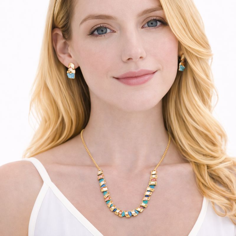Woman wearing KC gold plated enamel statement necklace and matching earrings