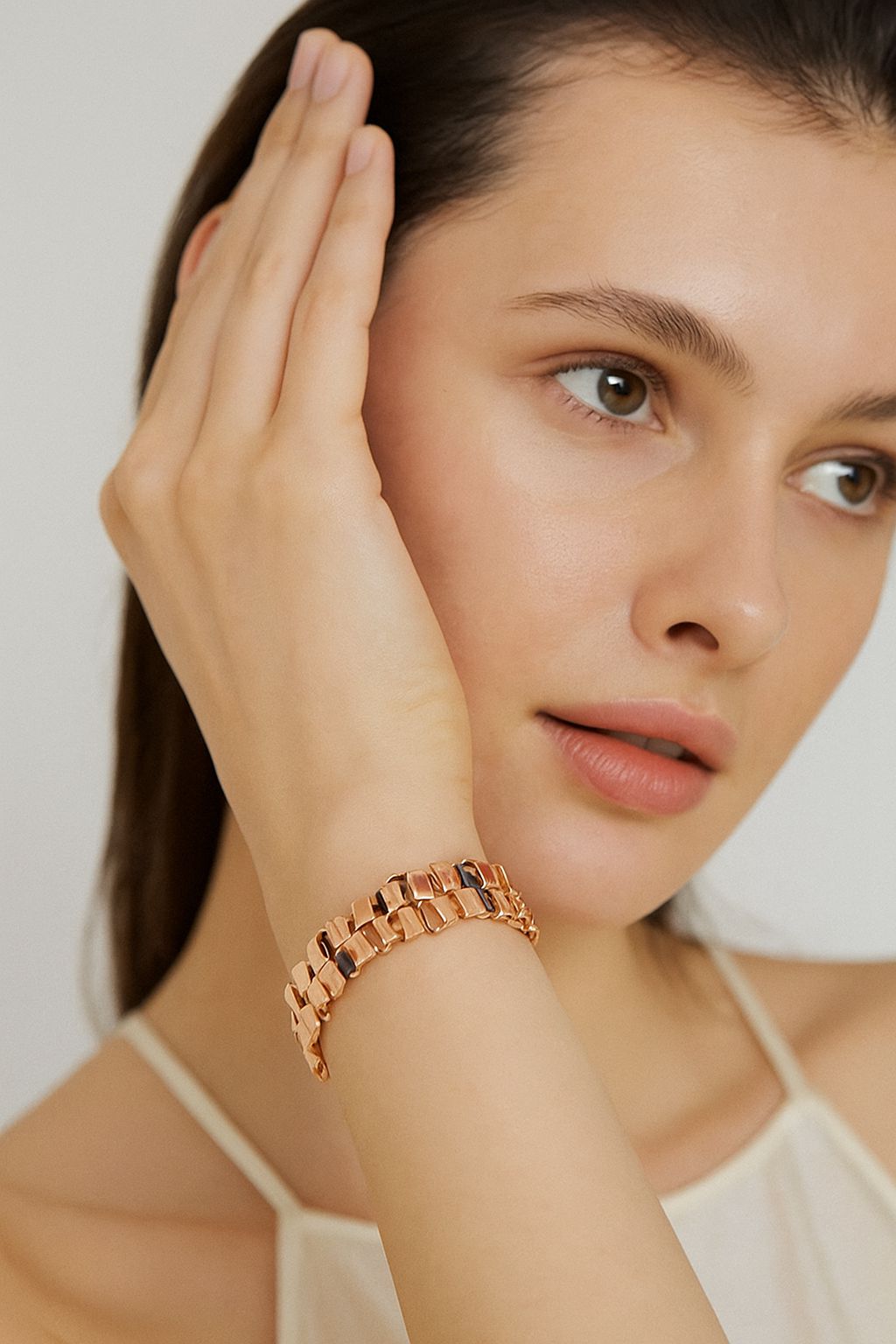 KC gold plated geometric bracelet with hand painted enamel on woman's wrist