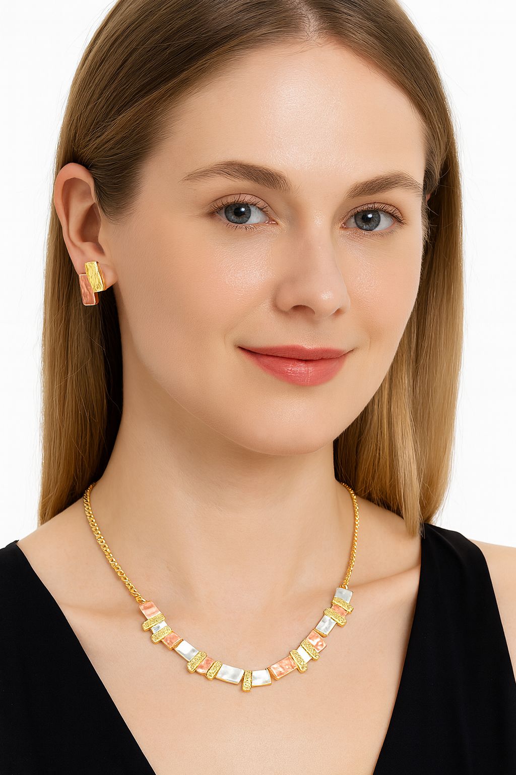 Model wearing modern geometric necklace set with coral and white enamel