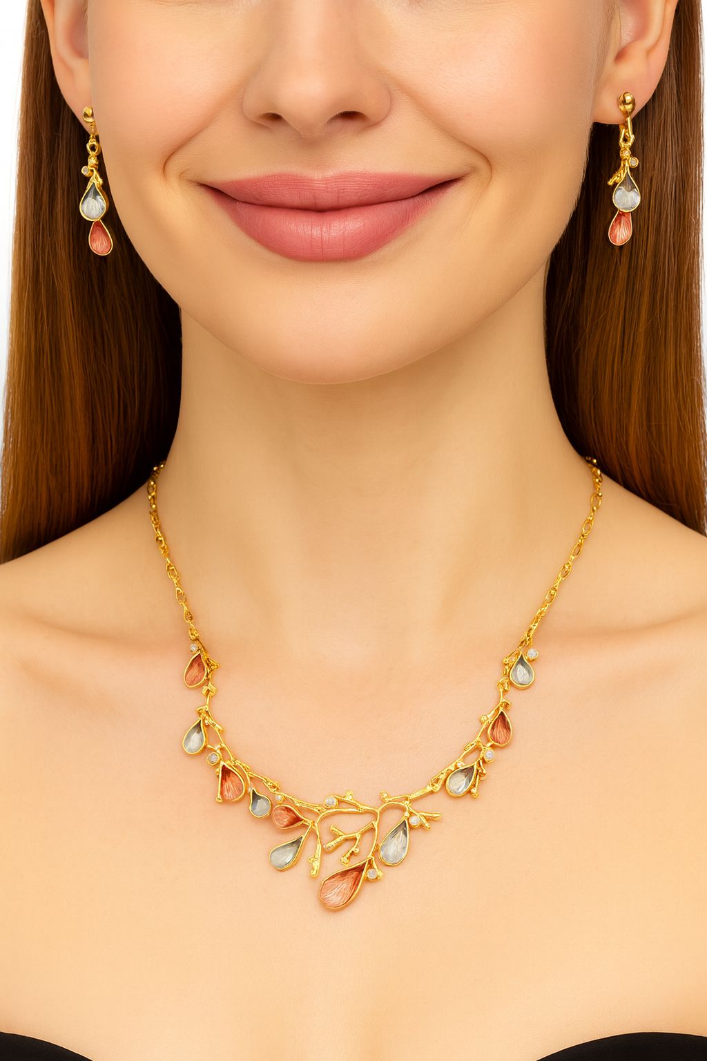 Model wearing gold branch necklace and teardrop earrings