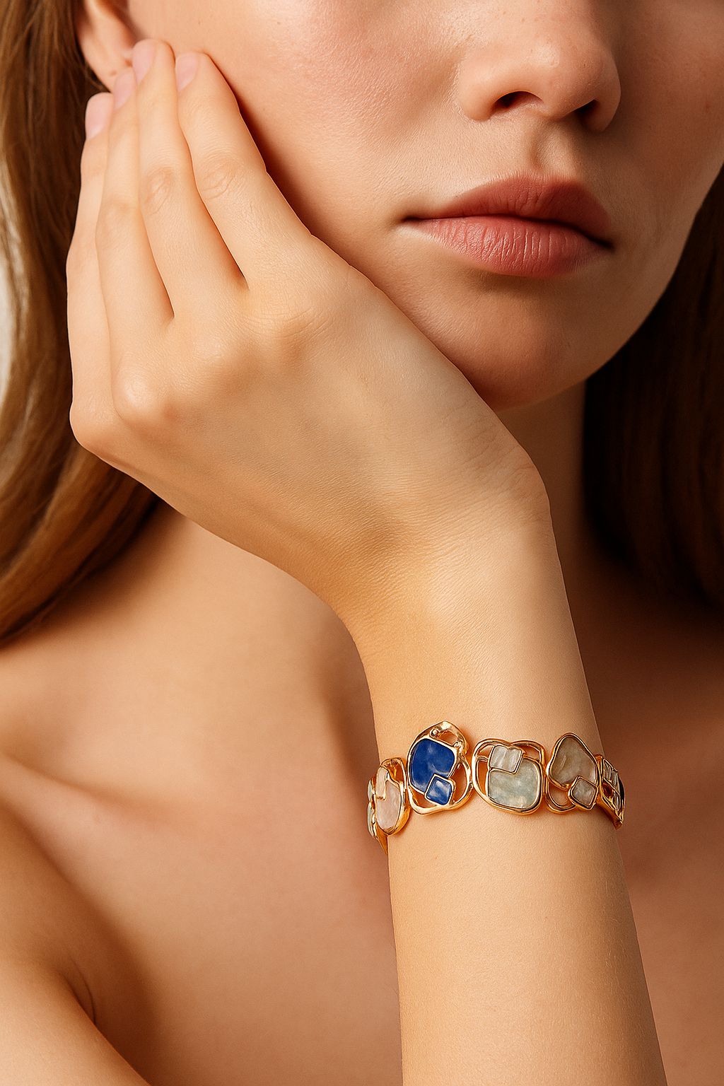 Women’s gold enamel bangle bracelet worn on wrist, modern artistic jewelry