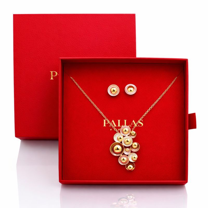 Gold plated enamel necklace and earrings worn by model