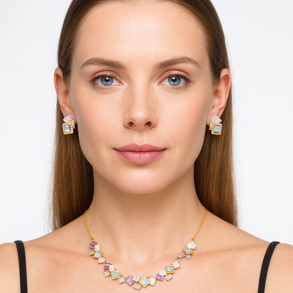 Model wearing hand-painted enamel gold necklace and matching earrings