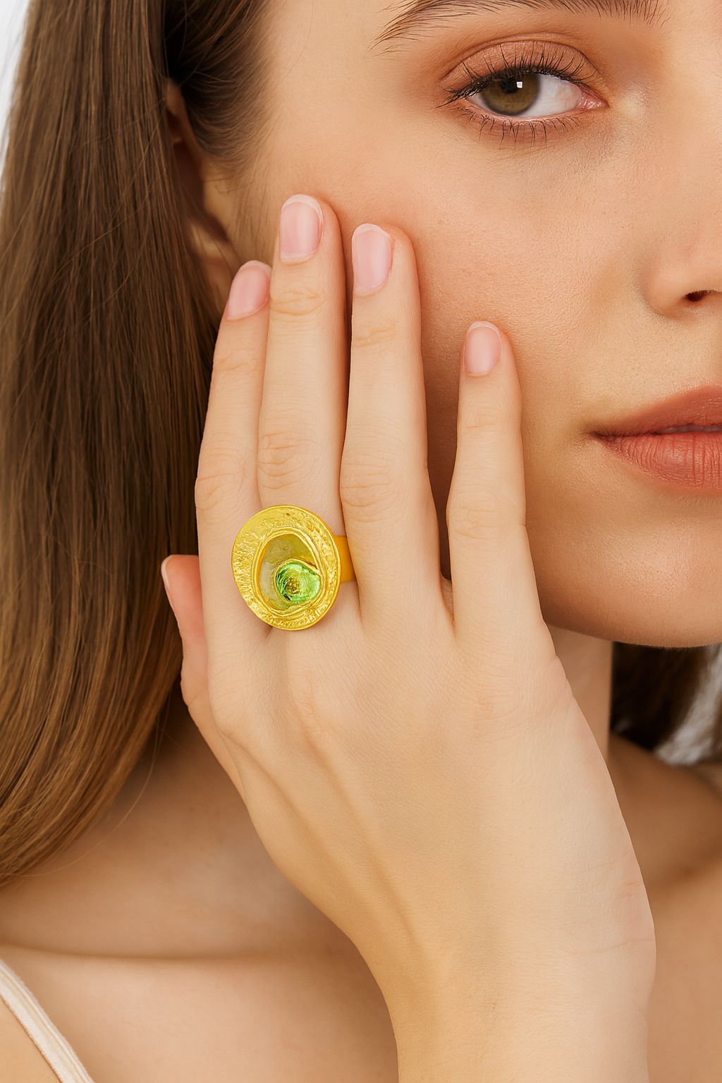 Women’s artistic gold ring on hand model