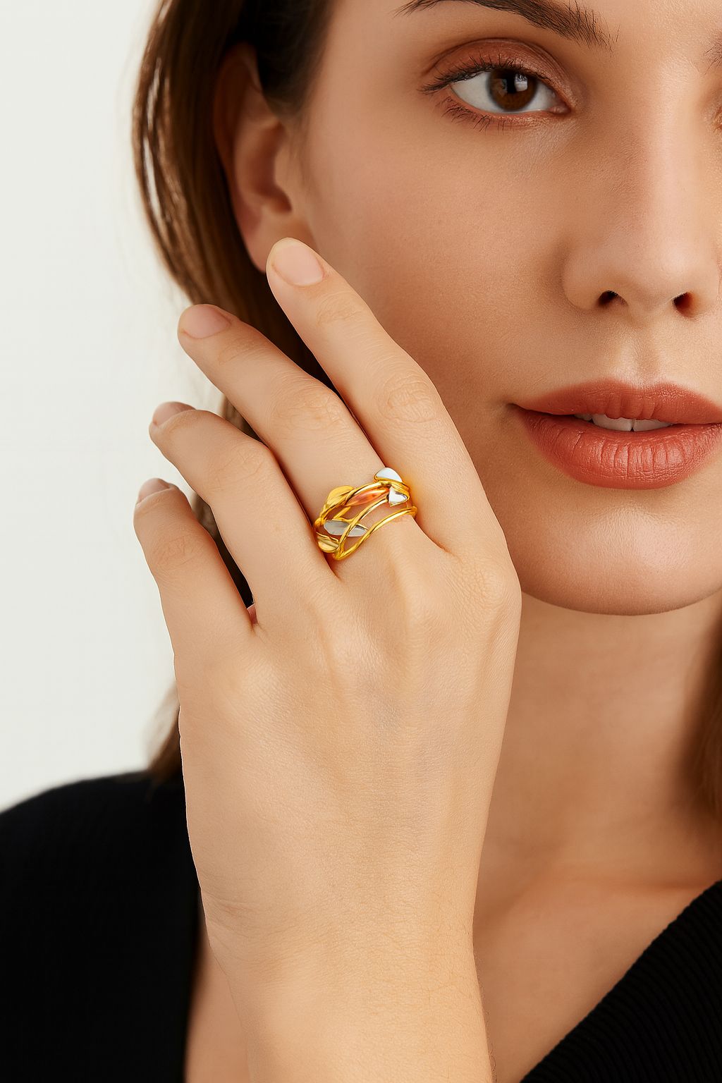 Adjustable gold leaf ring worn on model hand