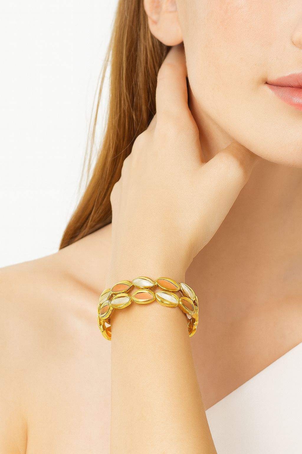 Gold KC-plated bracelet with handmade multicolor enamel oval links on woman's wrist