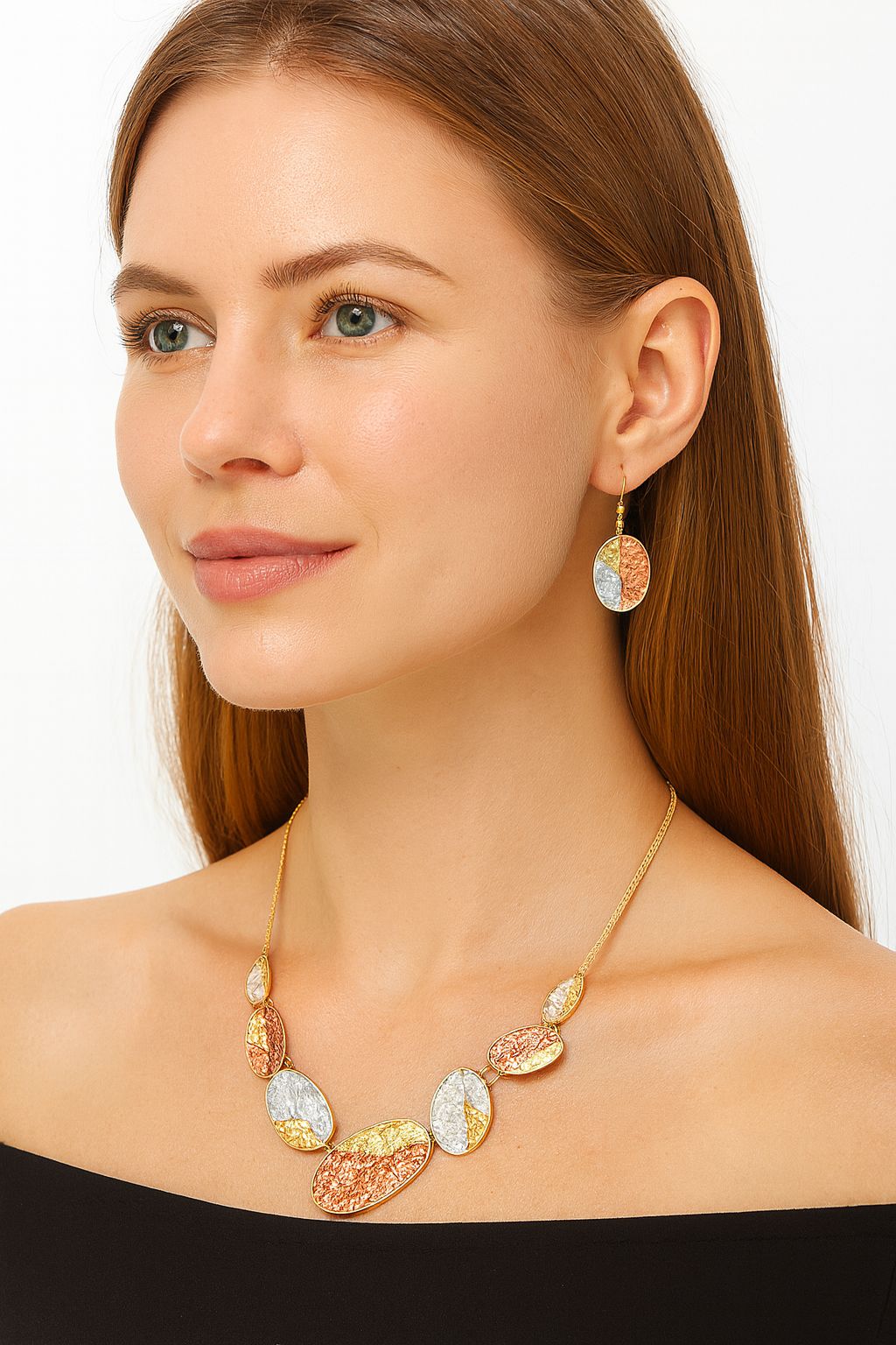 Model wearing gold plated oval necklace and enamel earrings