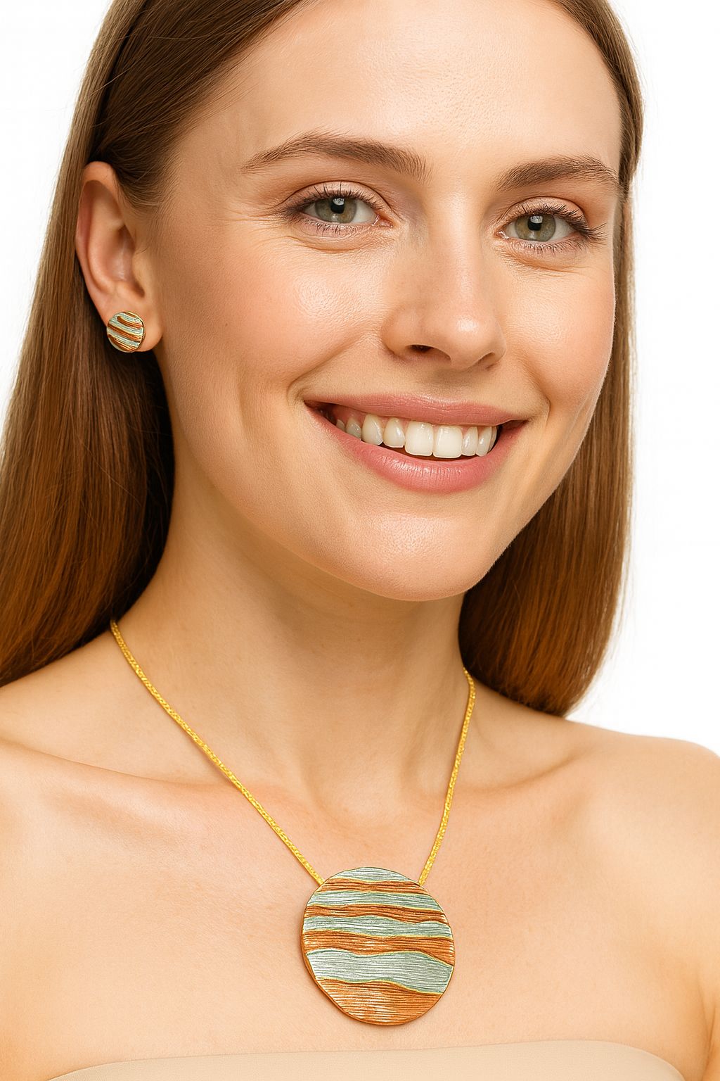 Model wearing artistic multi-tone pendant necklace and earrings