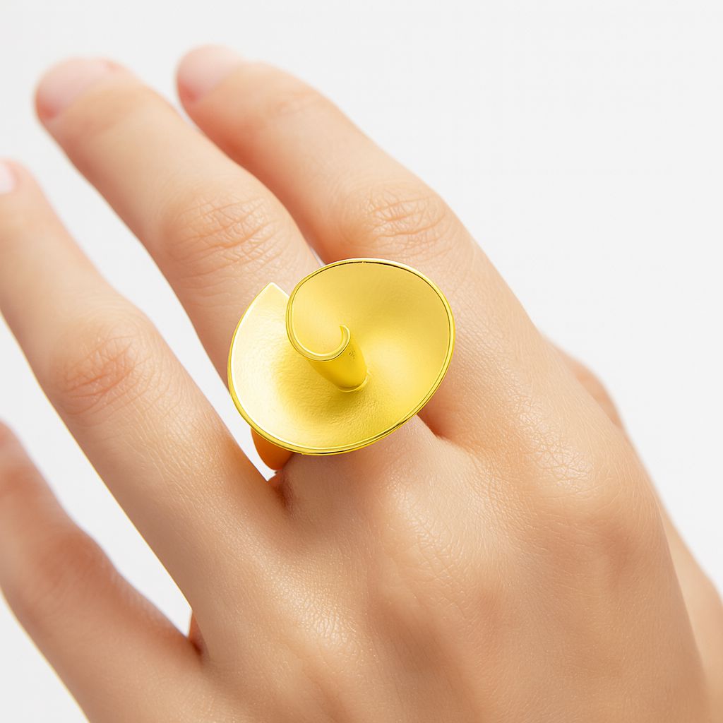 Model wearing artistic spiral gold statement ring