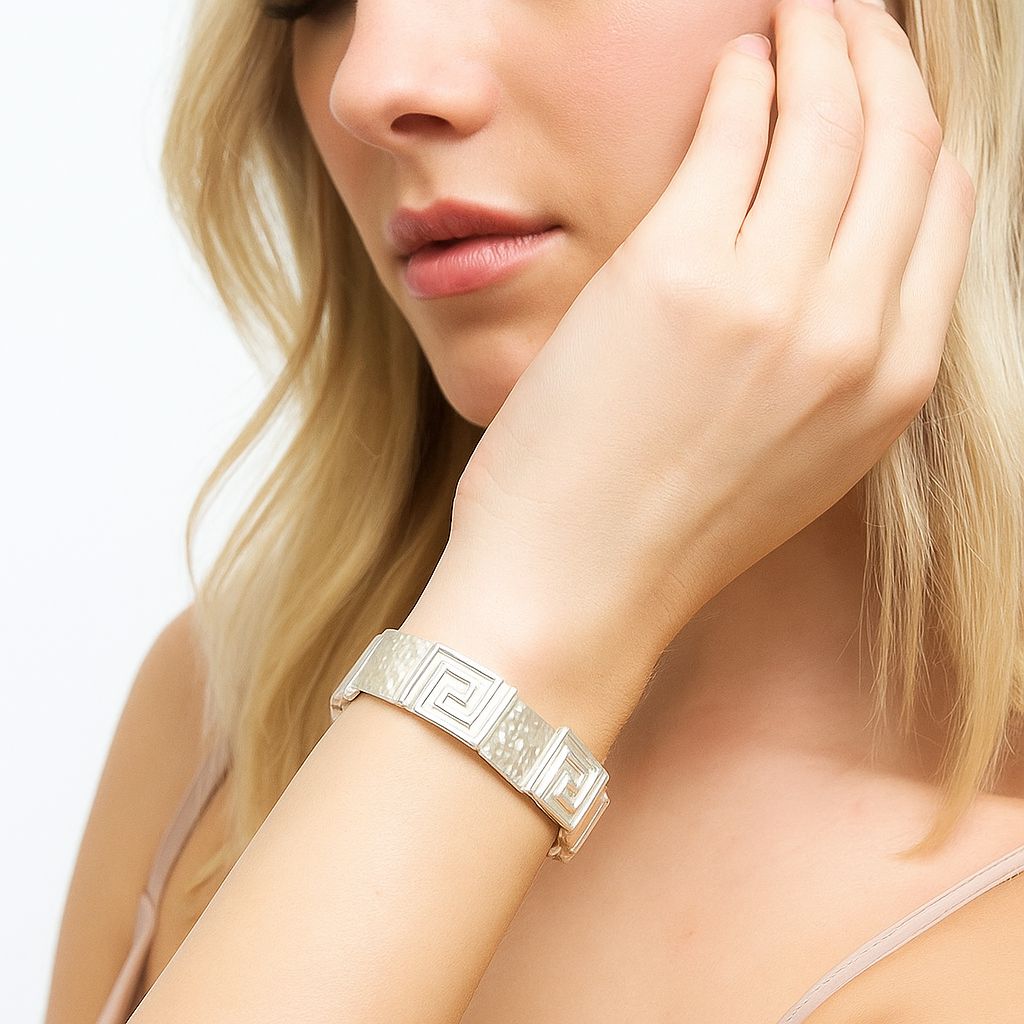 Model wearing white Greca pattern hand-painted enamel bangle bracelet, KC gold plated