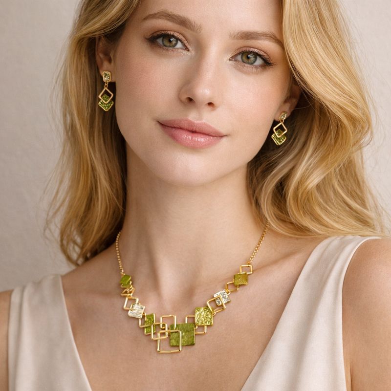 Woman wearing green geometric enamel gold necklace and earrings set
