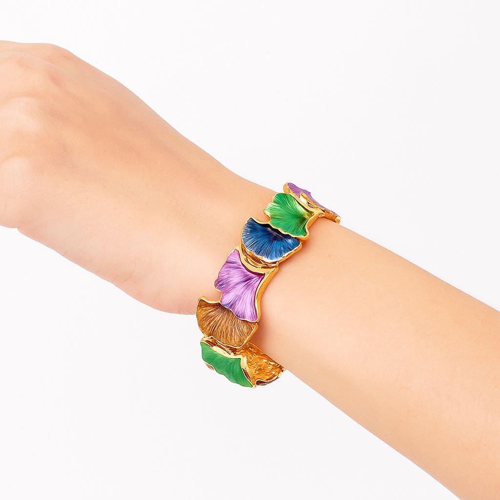 KC gold plated bracelet styled on wrist with colorful enamel