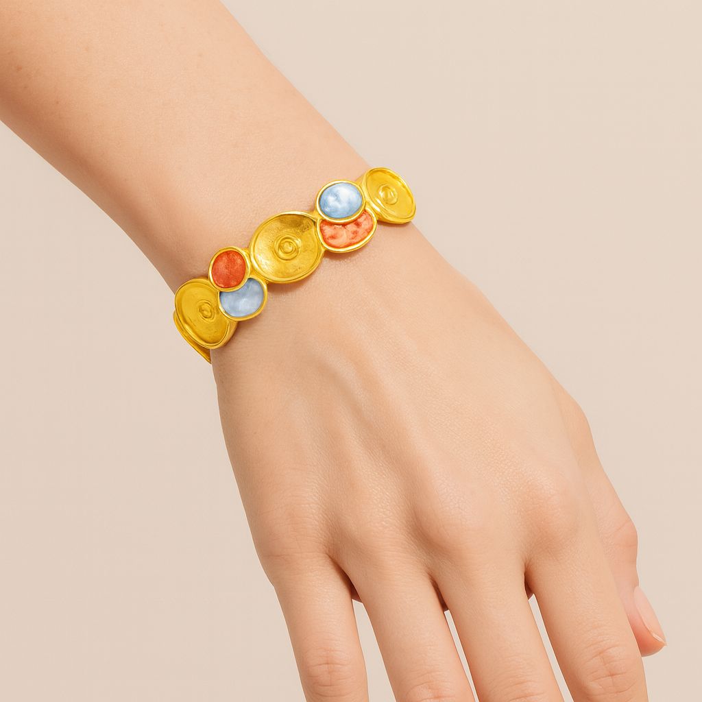 Close-up of enamel art disc bracelet in KC gold