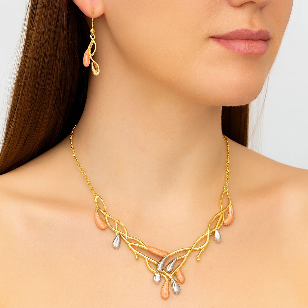 Close-up of enamel drop necklace with coral and pearl tones