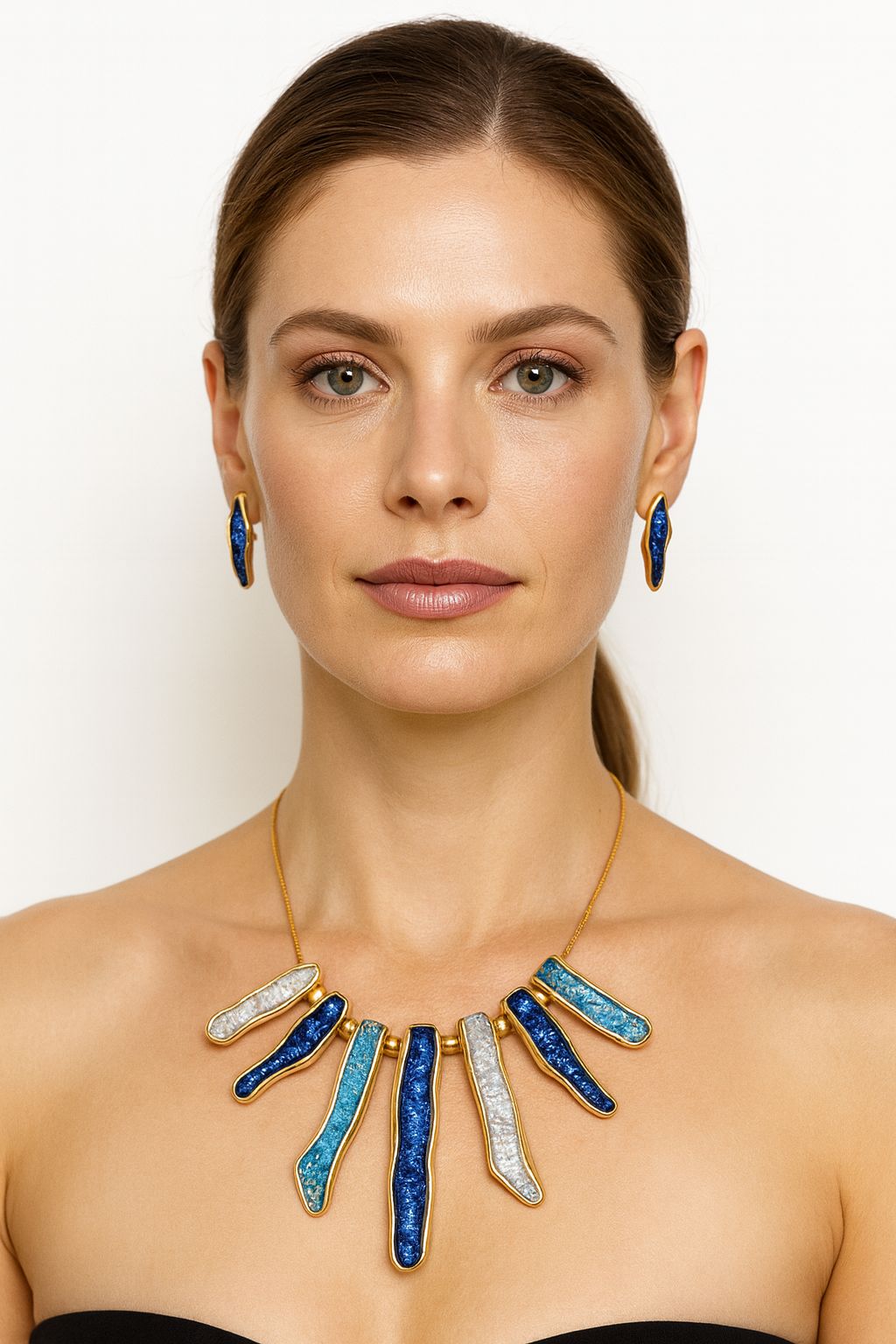 Gold tone hand-painted enamel necklace and earrings worn by model