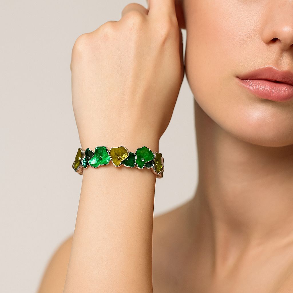 Green ginkgo-inspired enamel bangle shown on wrist